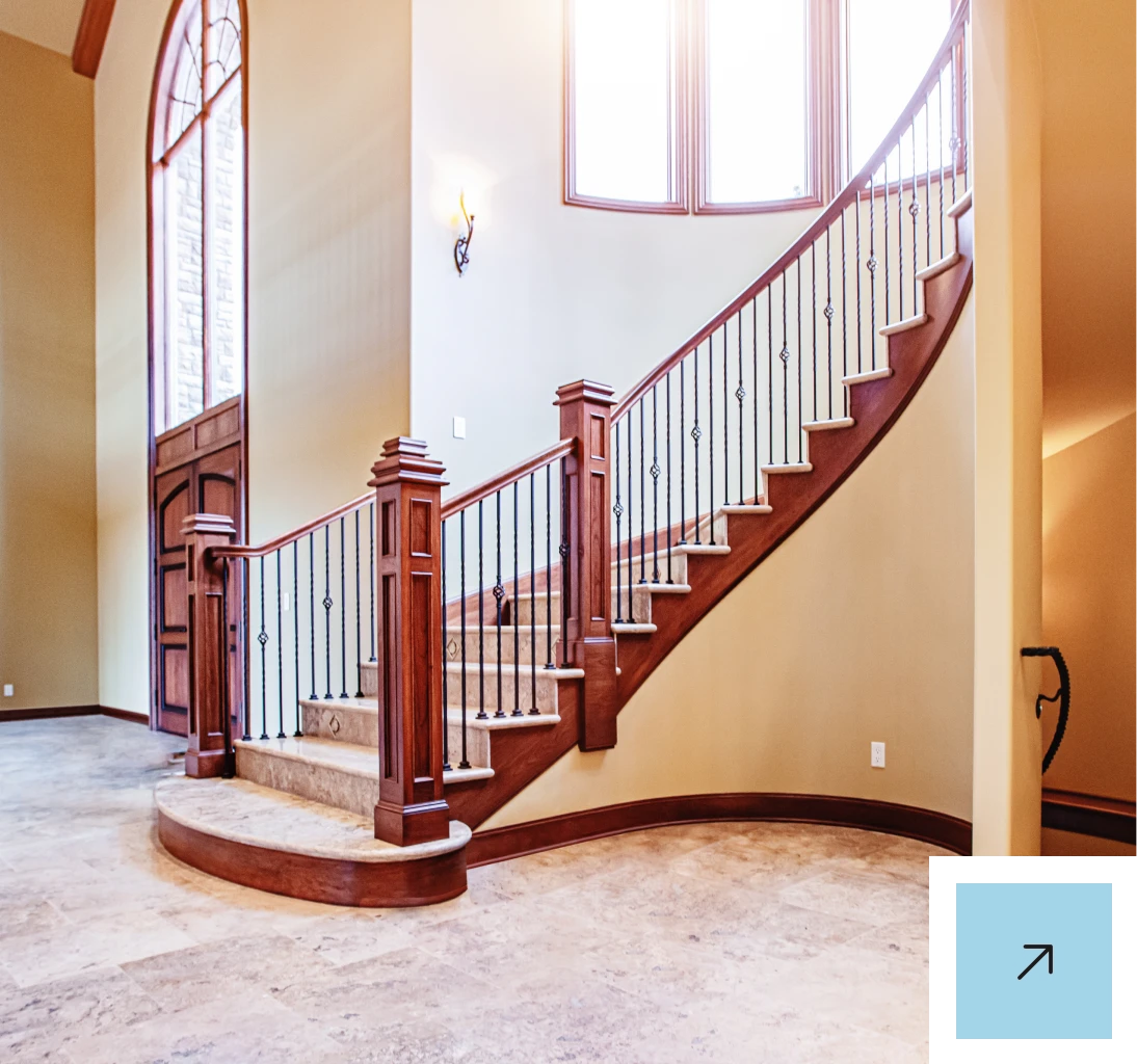Luxurious entryway with arched windows and stairs