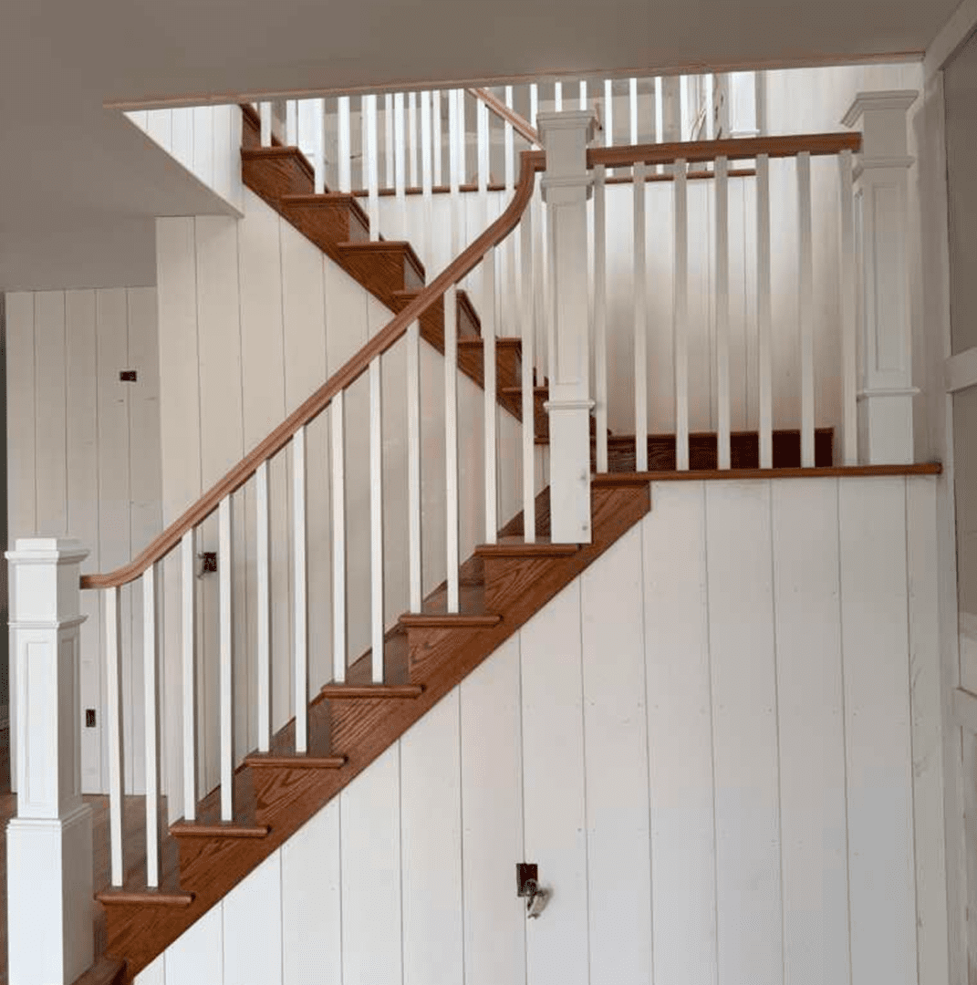 Modern wooden stairs with white panels